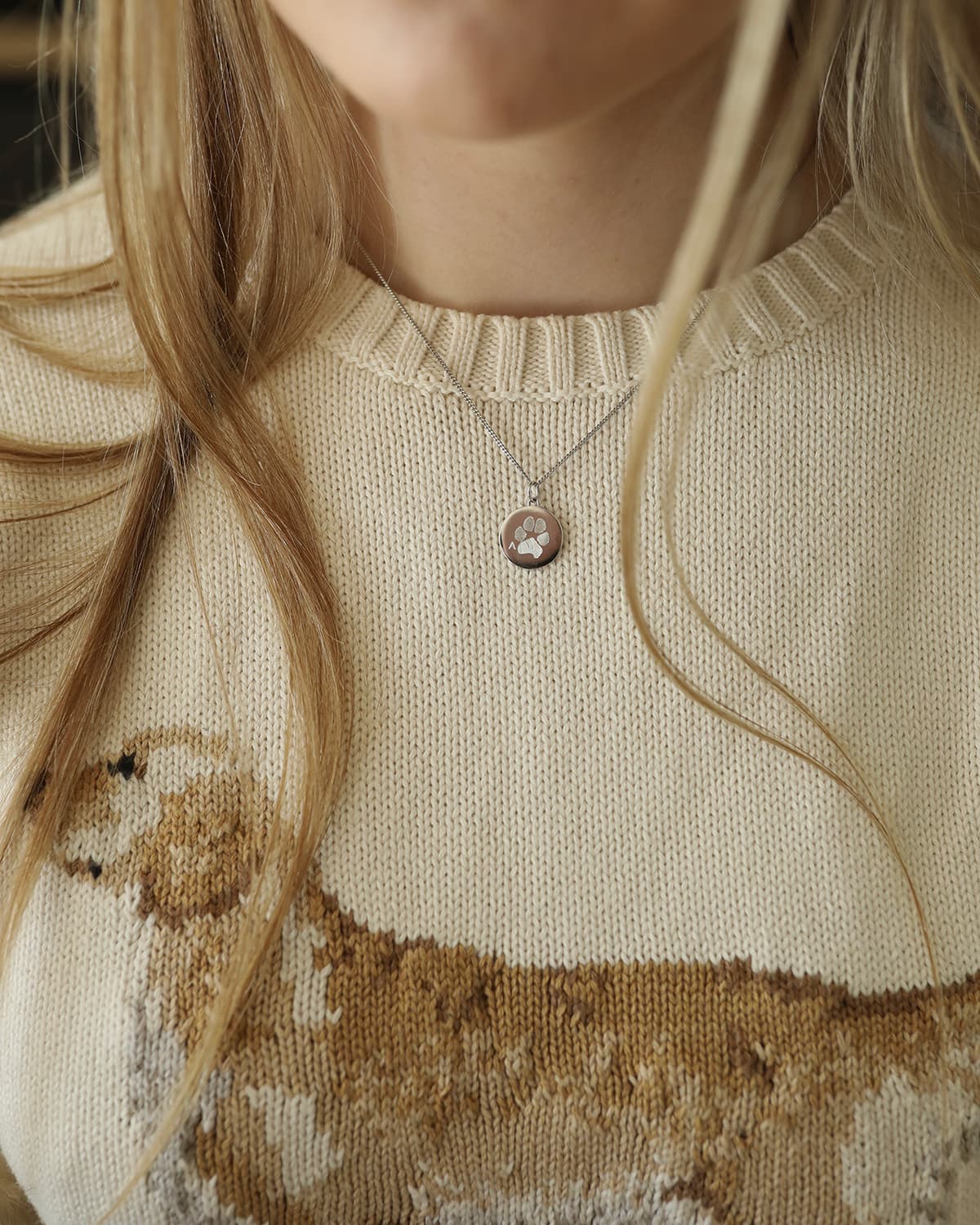 Silver coin pendant with engraved paw print