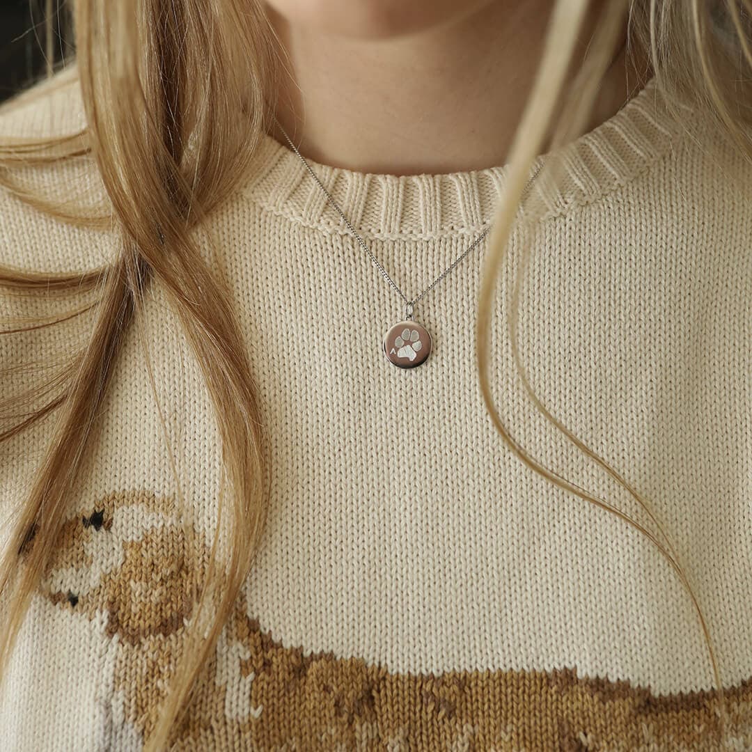 Silver coin pendant with engraved paw print